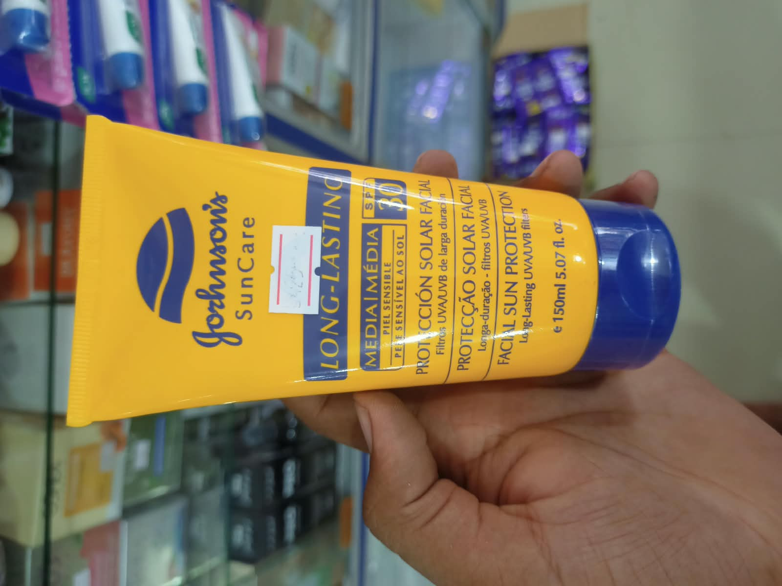 Johnson's Sun Care Long-Lasting Facial Sun Protection cream in a bright yellow packaging.