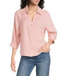 light pink long-sleeve button-down blouse features a classic lapel collar and unique decorative button detailing along the front placket