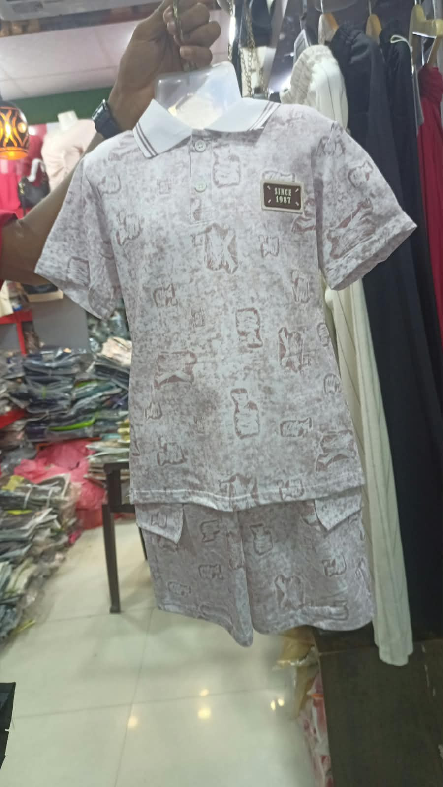 children's two-piece short-sleeve polo and shorts set featuring an all-over printed pattern.