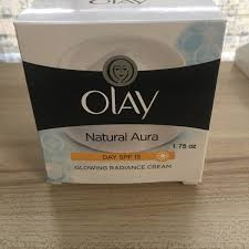 Olay Natural Aura Day Cream SPF 15 featuring a white and black colorway with yellow and blue accents.