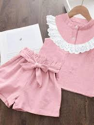 pink sleeveless children's two-piece outfit featuring a charming white lace-trimmed collar and matching shorts with an integrated bow belt