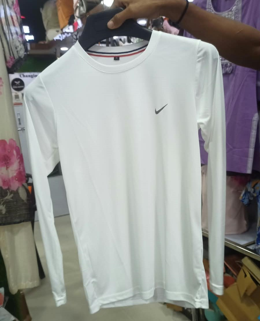 white Nike long-sleeve athletic top featuring a small black Swoosh logo on the chest and a red-and-blue striped trim inside the collar