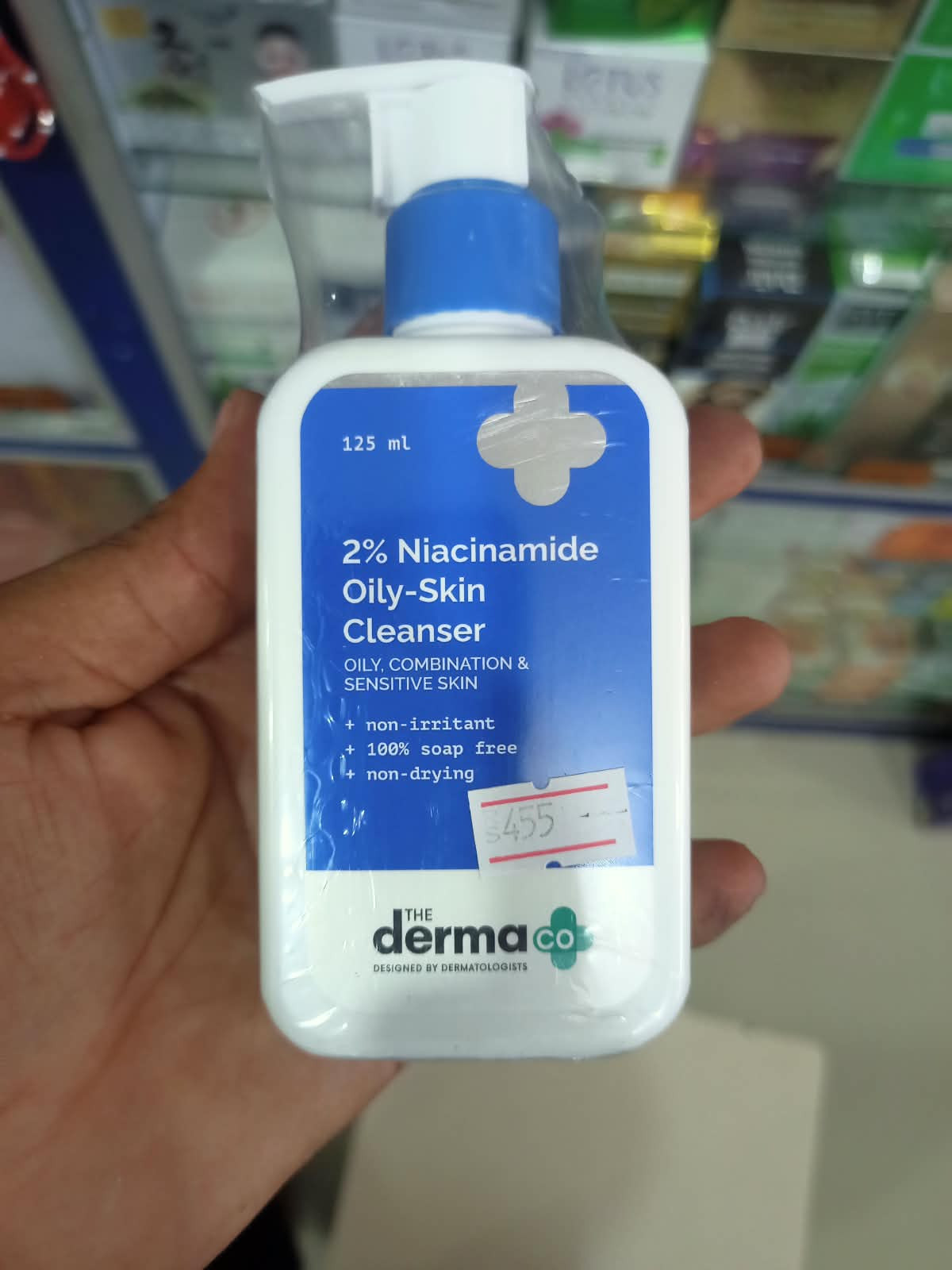 The Derma Co 2% Niacinamide Oily-Skin Cleanser (125 ml) appears to be a white pump bottle featuring a blue label.